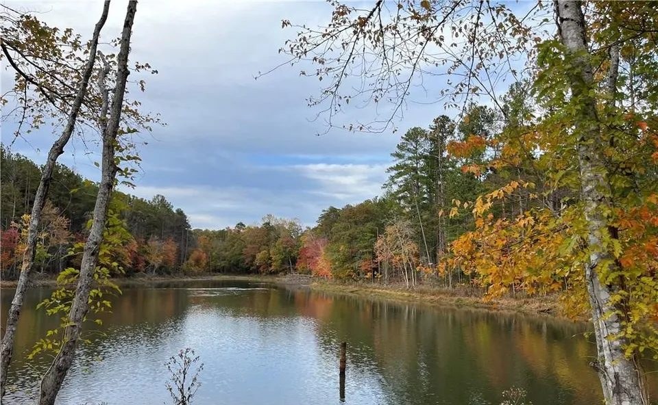 The lake at Southern Pine Lake framed by hardwoods in autumn colour.
